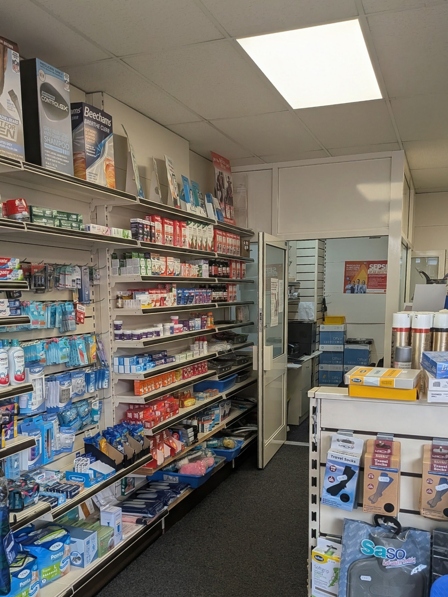Dental care, first aid and travel socks displayed near the consultation room door